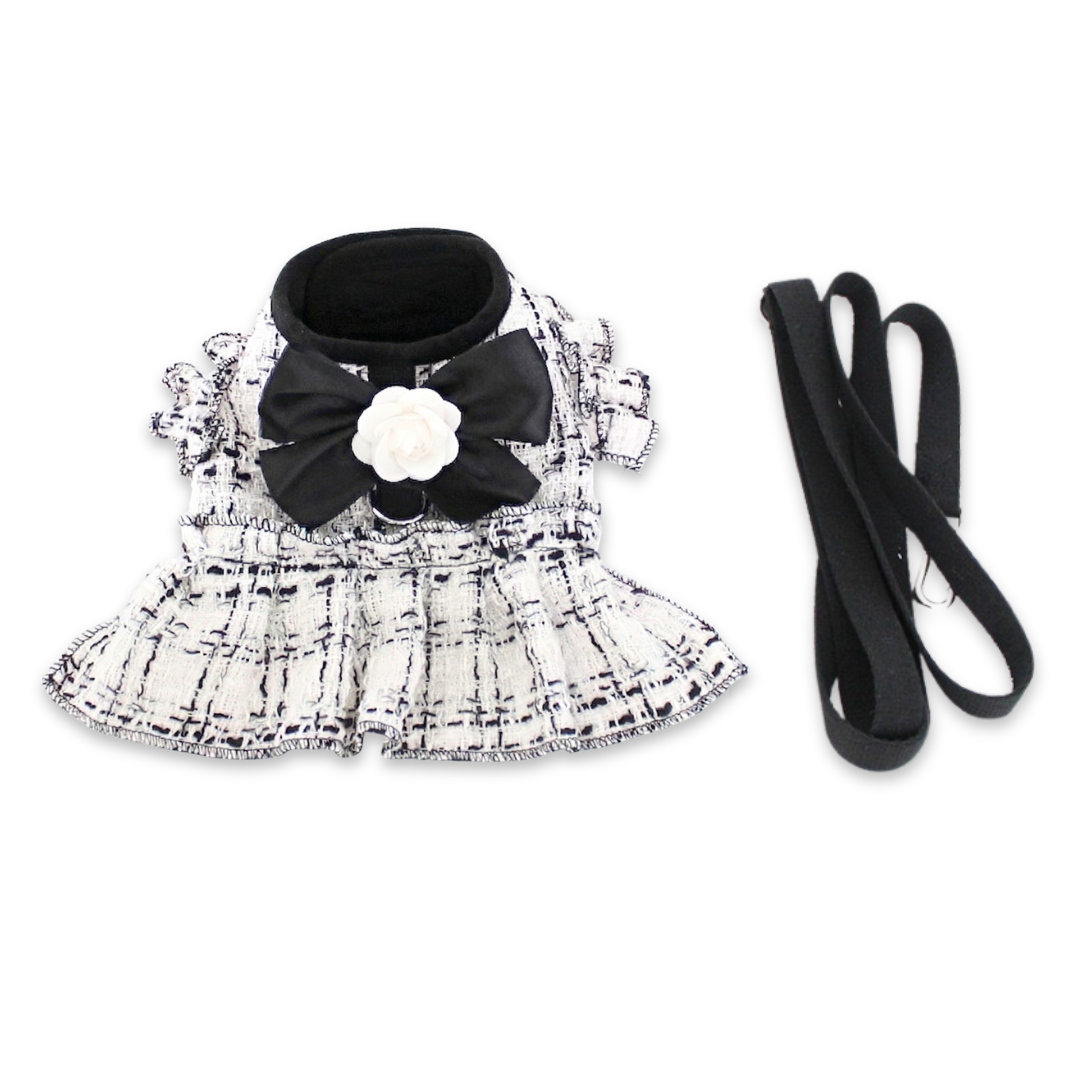 White tweed dog harness dress with black bow and flower detail Chanel style