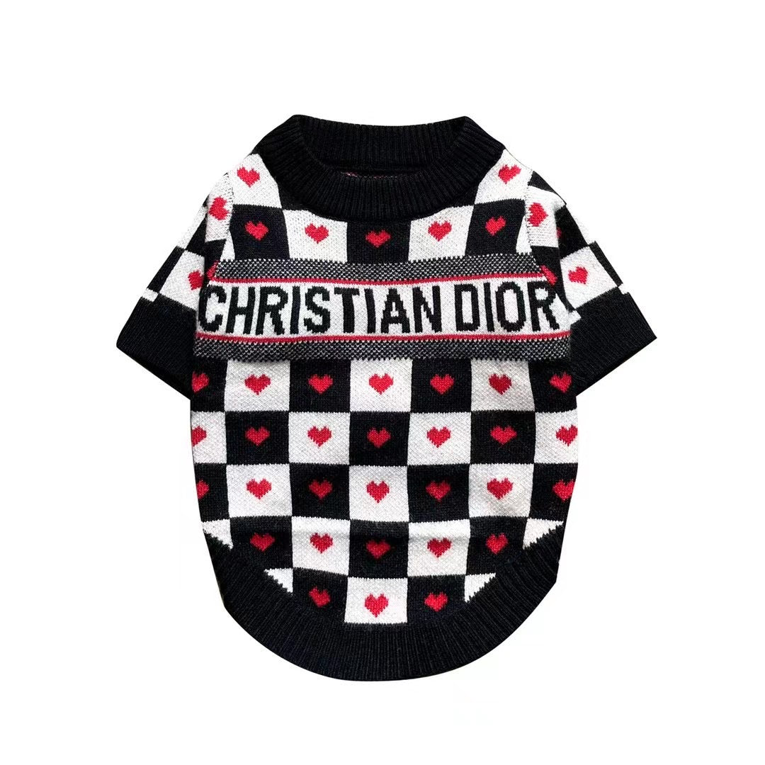 Black and white checkered dog sweater with red hearts and Dogior branding on white background